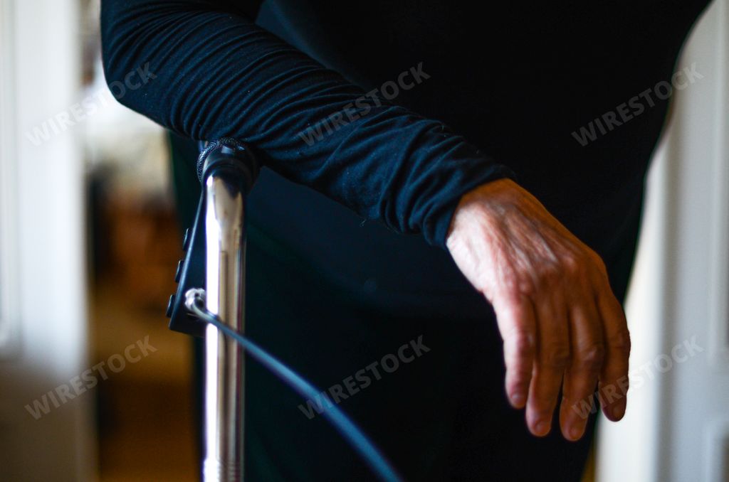 An aged female walking with walkers