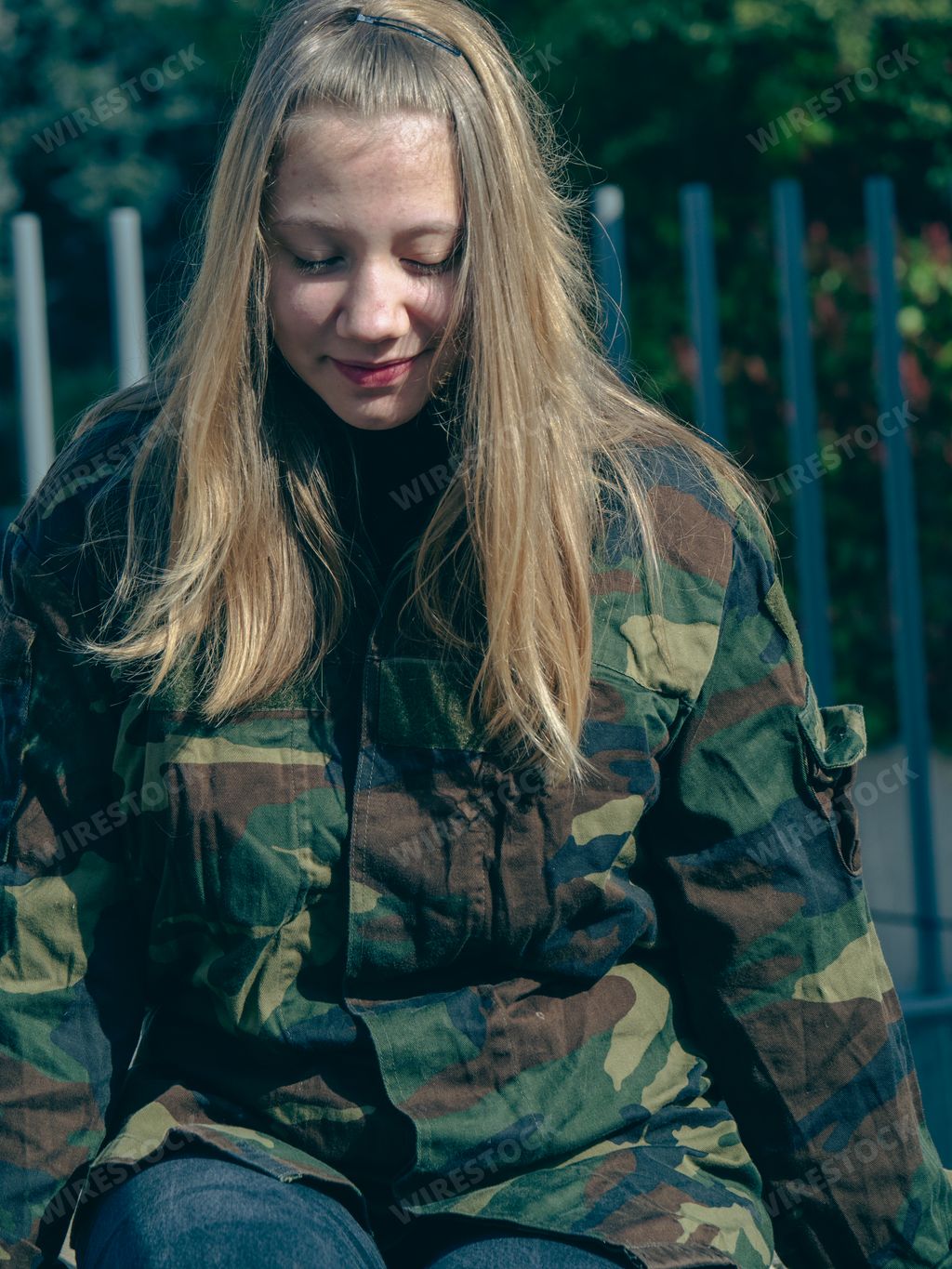 A female soldier in camouflage with rifle during Russia and Ukraine collision outdoors