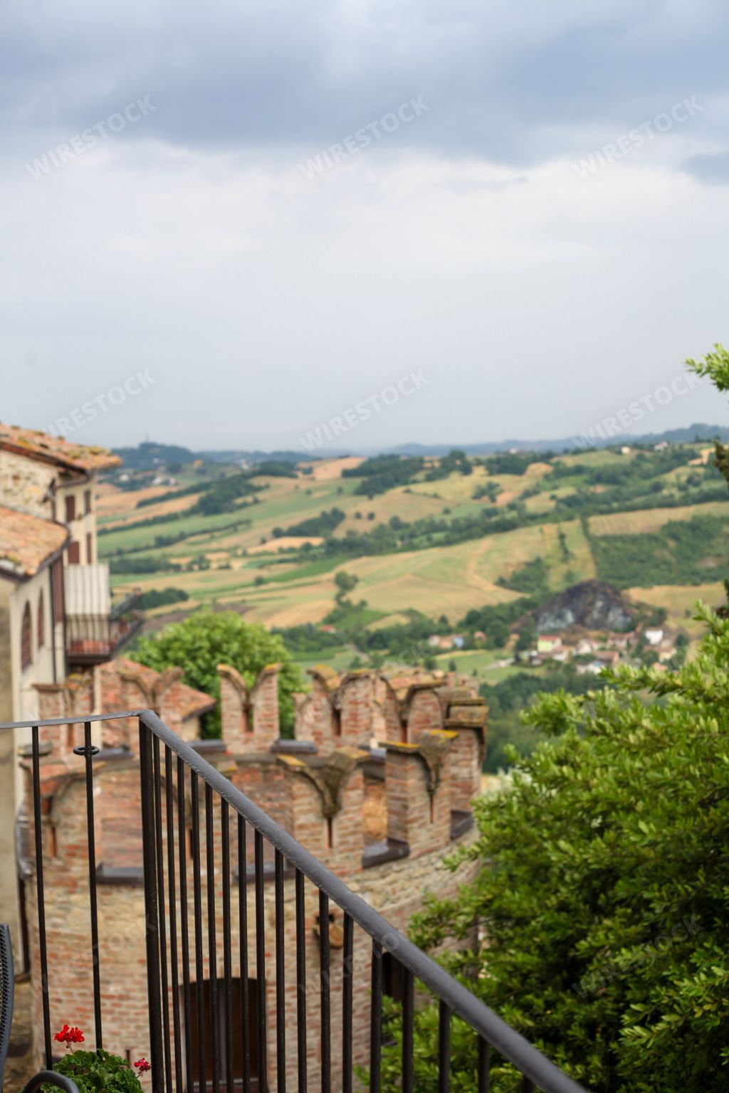 a vertical shot of a tower of Vigoleno castle in Piacenza Italy - shot from near a balcony rail