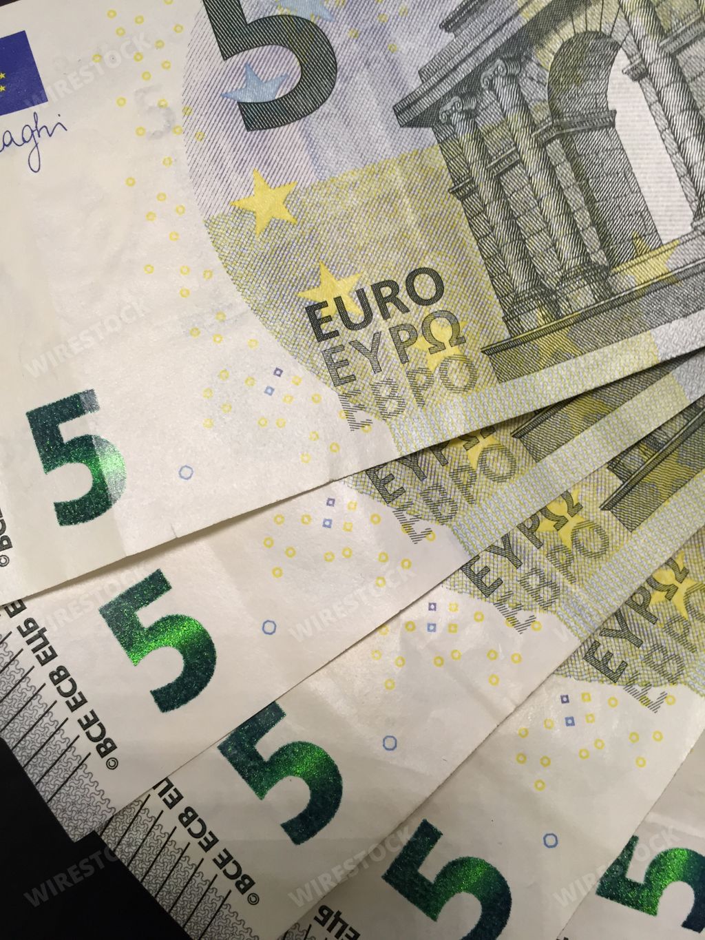 a vertical shot of five euro banknotes semicircle