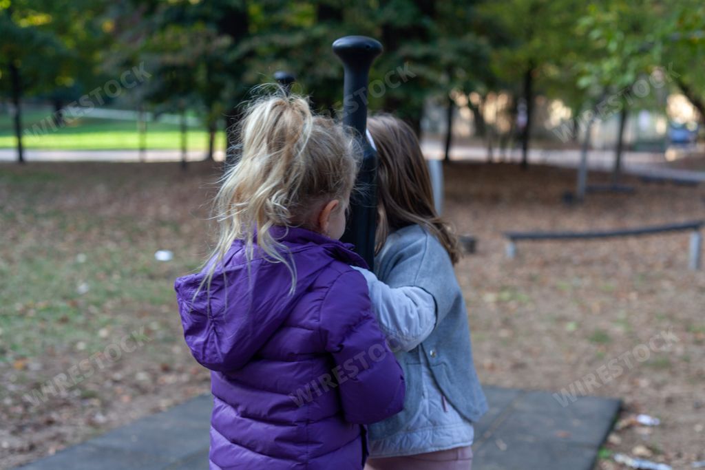 Adorable little girls playing together in the playground