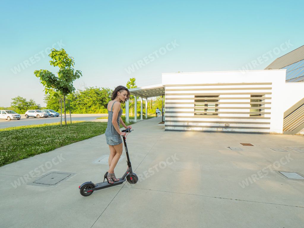 Young hispanic thin girl dressed elegant riding an  electric scooter