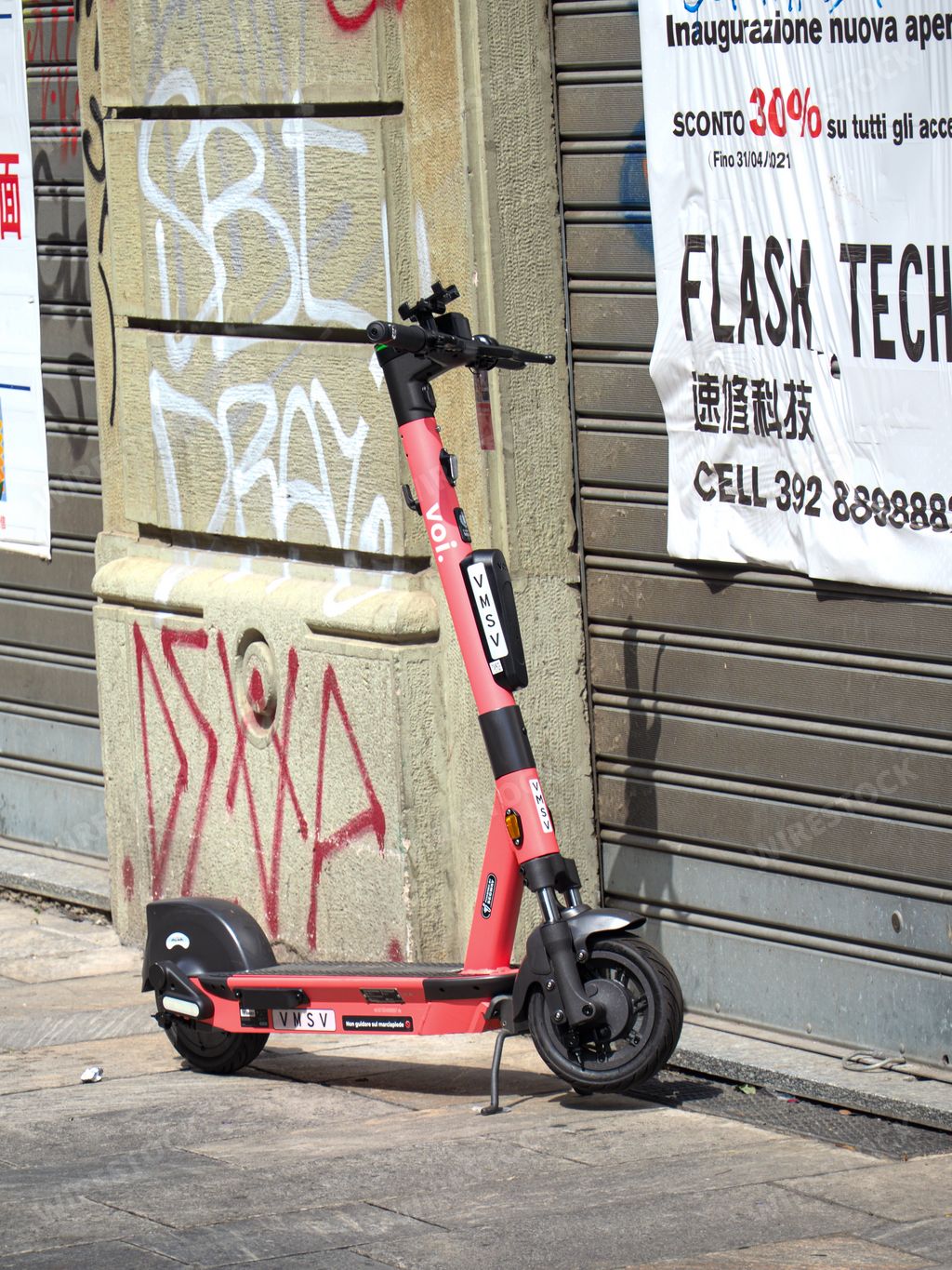 A vertical sh Voi electric scooter for rental mobility in Milan, Italy
