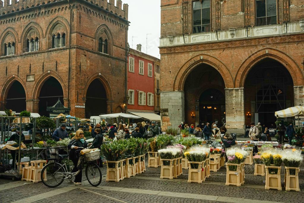 A fashionable old street market abounding with different sorts of fresh food in Cremona, Italy