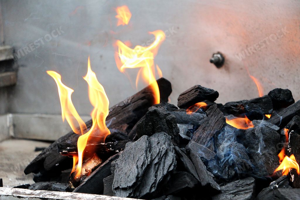 A horizontal shot of burning firewood and coal