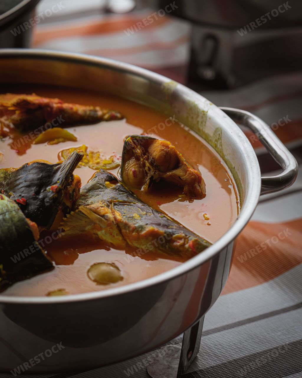 Ikan Patin Masak Tempoyak in stainless steel pot. Patin Tempoyak fish in durian sauce is a famous Malaysian heritage dish and it taste spicy.