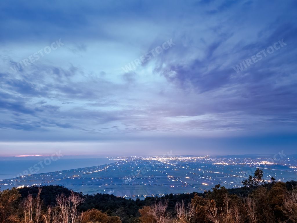 From the top of Gunung Jerai during sunset overlooking the Sungai Petani town. dawn or sunset time.