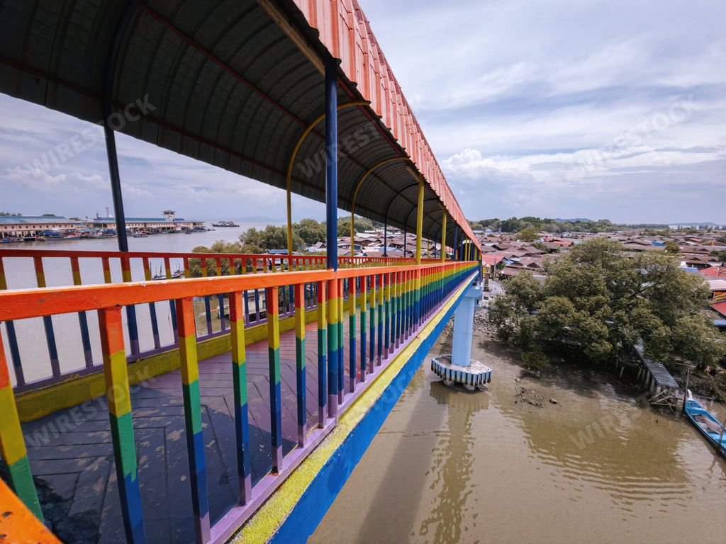 Rainbow bridge in Kuala Perlis. View of the colorful metal bridge extends across the fishing village. Selective focus.