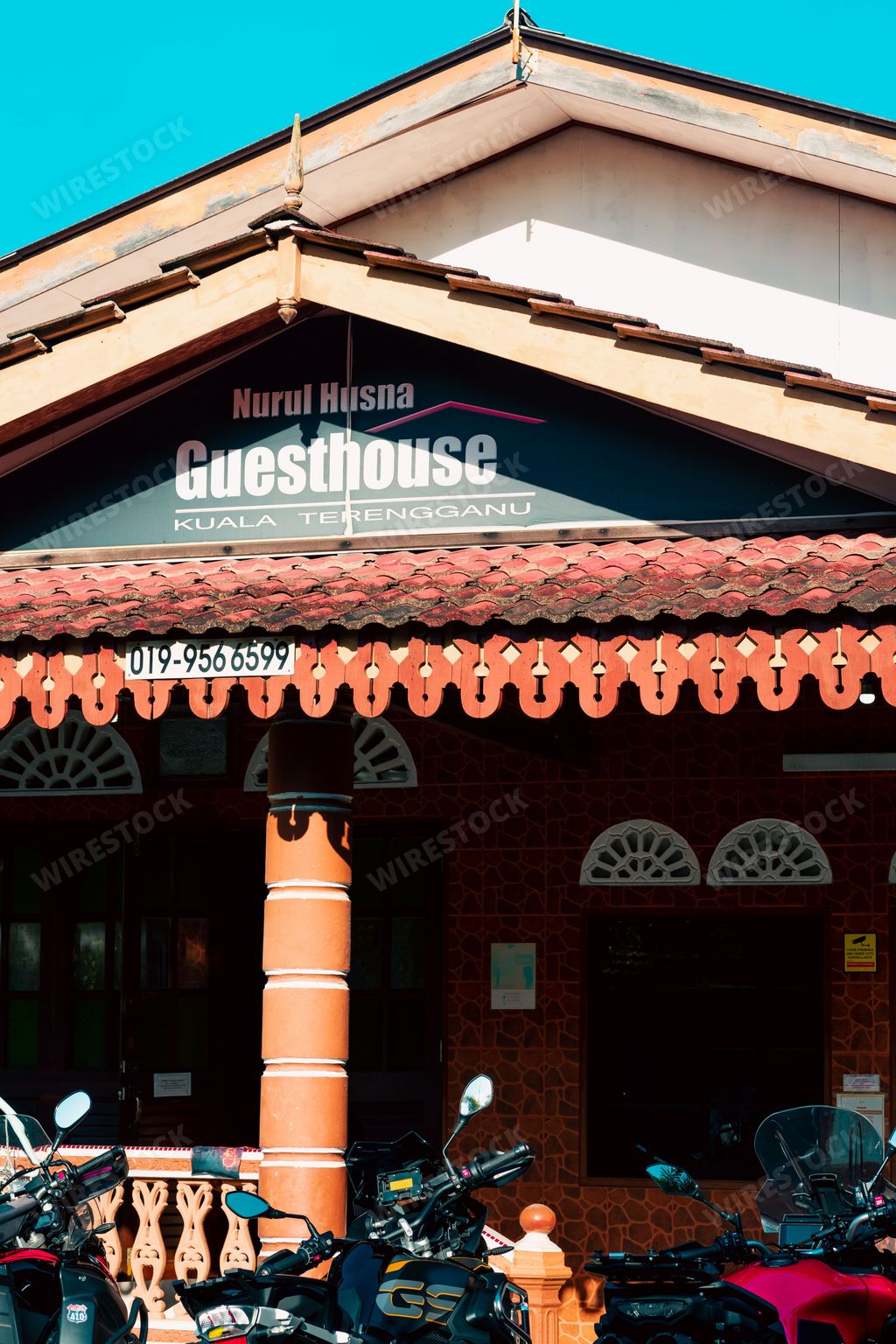A vertical shot of Nurul Husna Guesthouse or Homestay for travelers on a sunny day