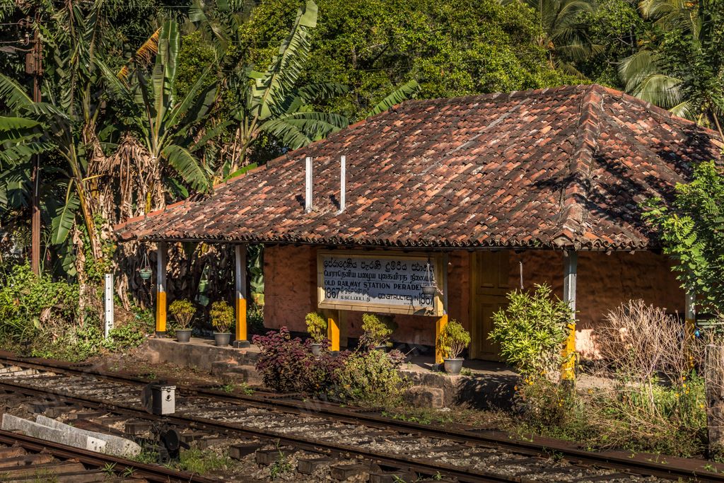 A train station in a rural area is depicted in this image