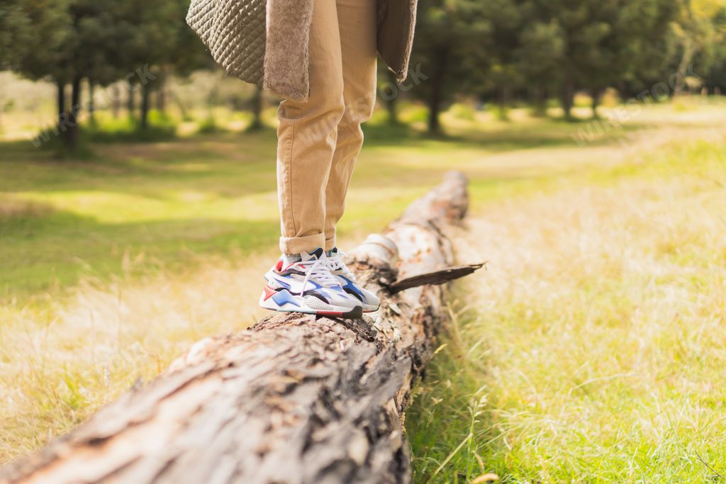 A young Hispanic woman walking through nature, enjoying the scenery