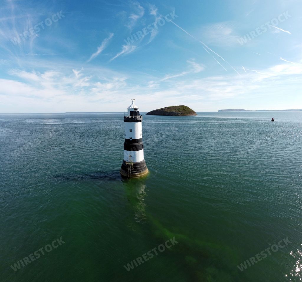 An aerial view of the famous Penmon Lighthouse on a sunny day