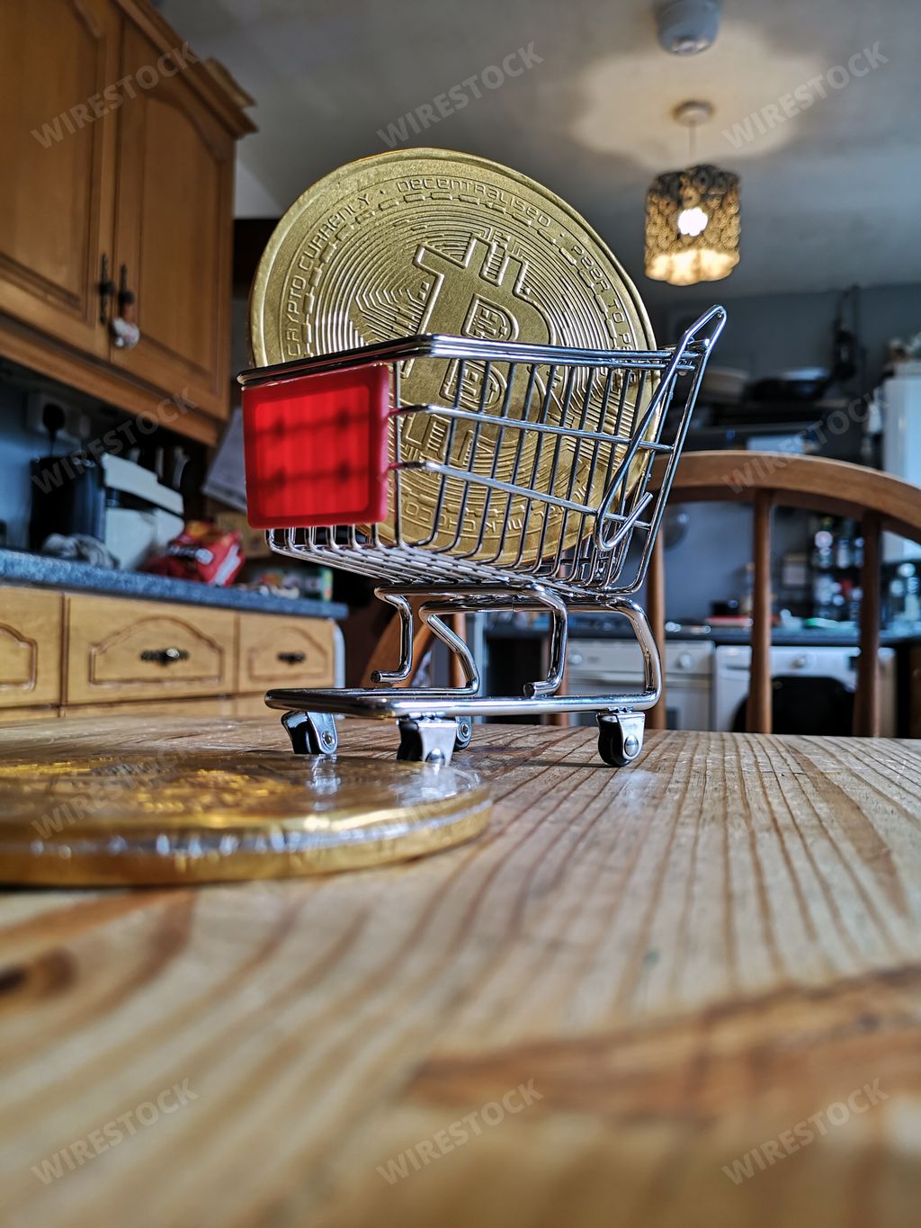 A vertical closeup of the bitcoin in the shopping cart on the kitchen table.
