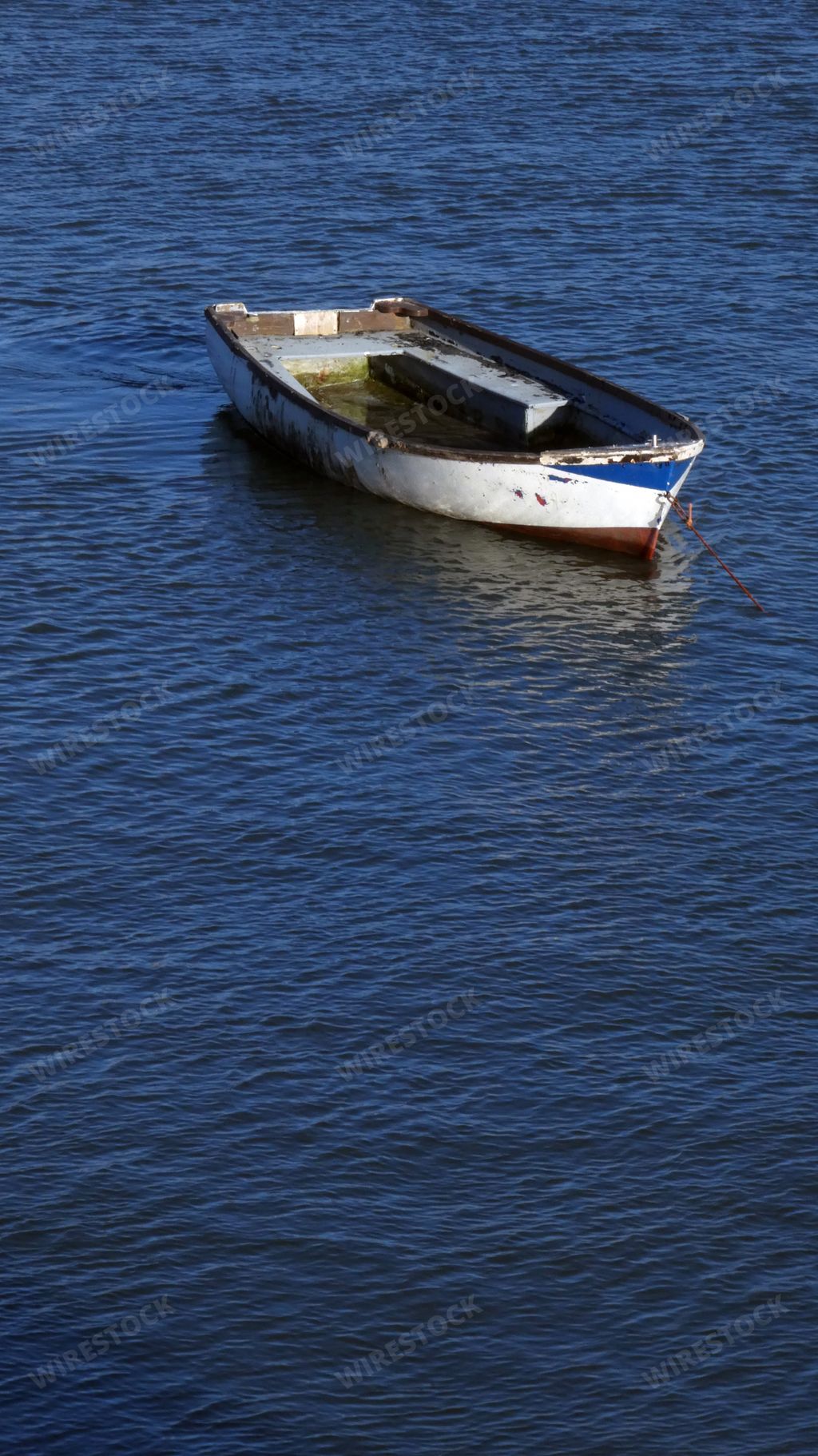 A vertical shot of an empty boat in the sea