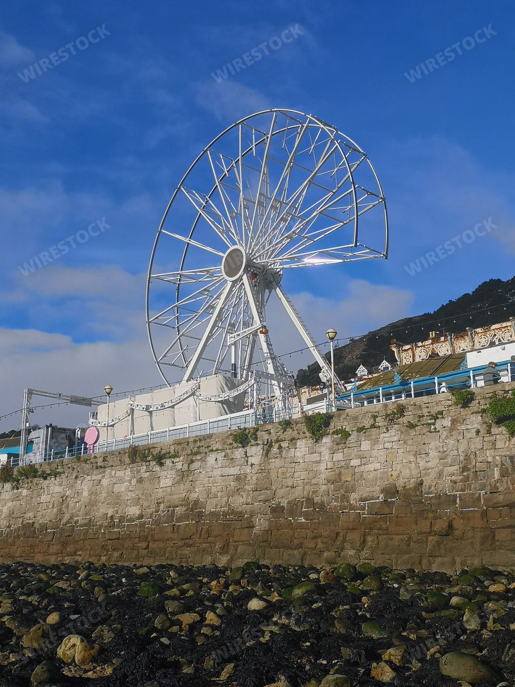 A Llandudno pier Ferris wheel under the blue sky