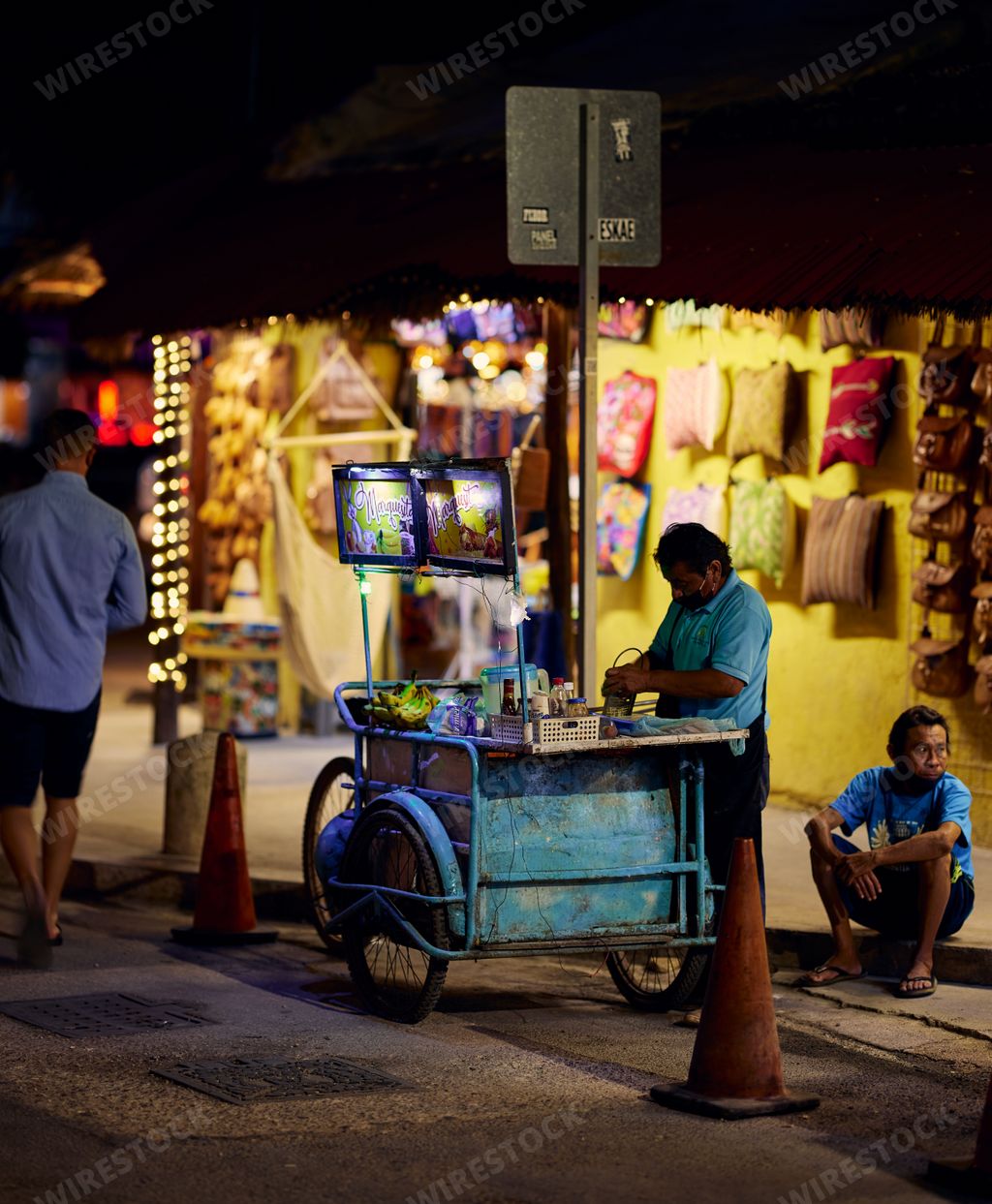 The streets of Tulum, Mexico at night with various street vendors selling clothing and offering food