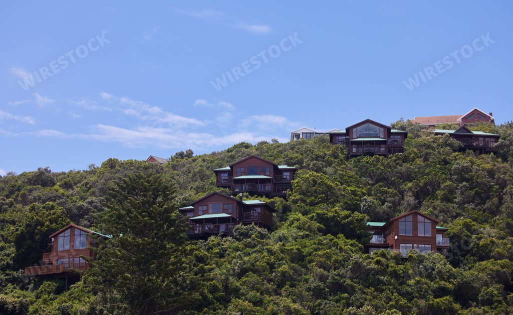 A beautiful view of houses surrounded by trees garden route of  South Africa