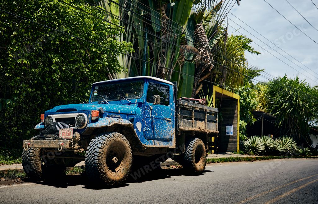 A closeup shot of a dirty heavy Toyota Landcruiser on a road in Puerto Viejo Costa