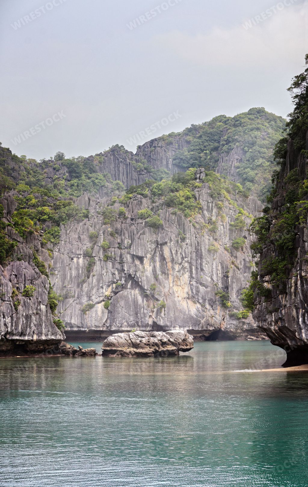 A vertical shot of the picturesque cliffs of Halong Bay under the blue sky, Vietnam