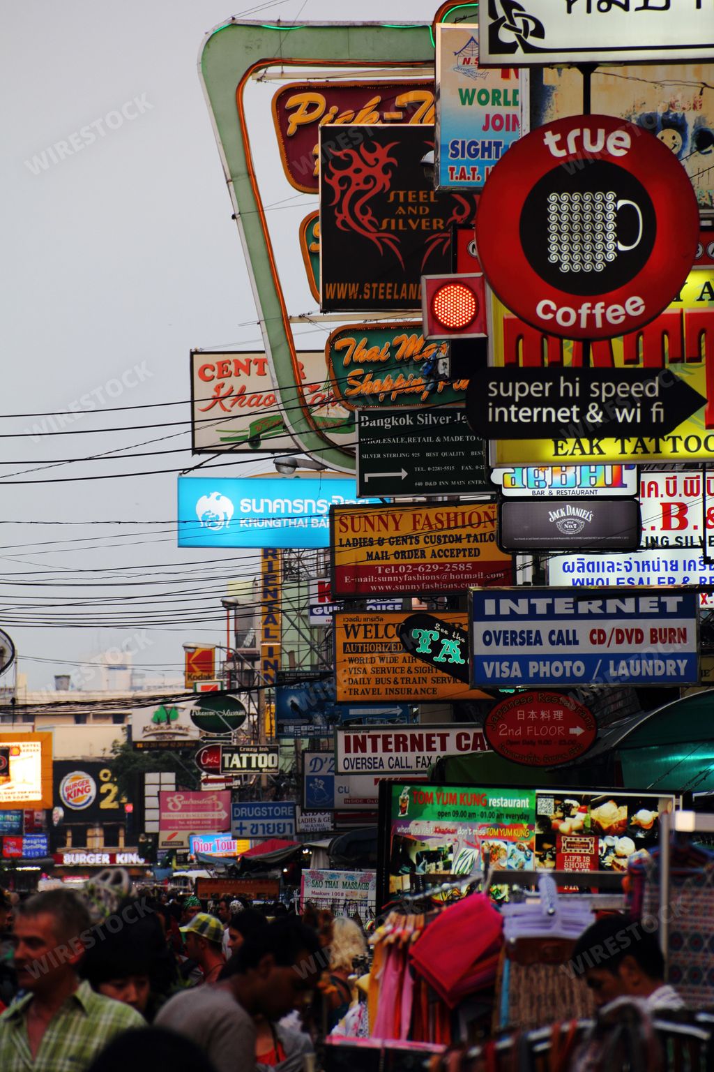 A bustling city street packed with people and advertisements. Bangkok.