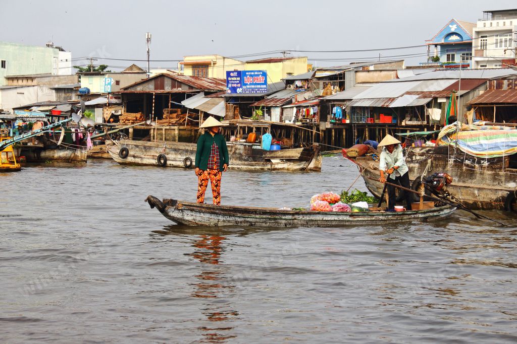 Two men in the small boat at the Mekong river village in Vietnam, the concept of a daily life