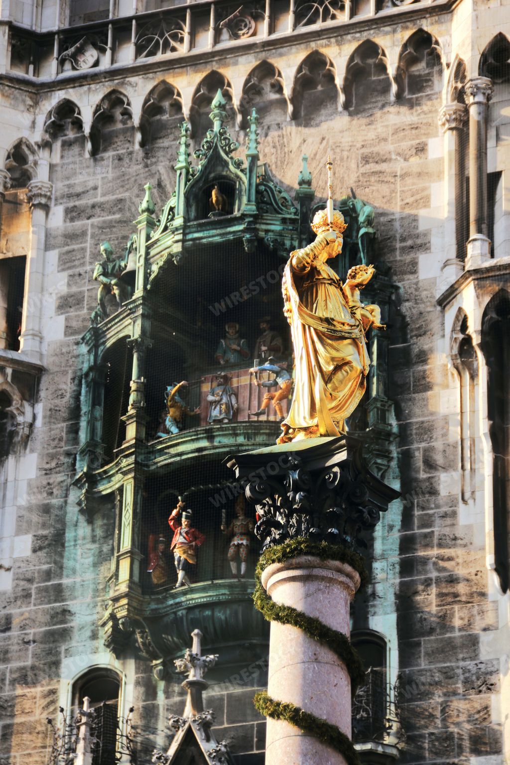 Golden statue in front of the famous town hall building in Munich Bavaria Germany