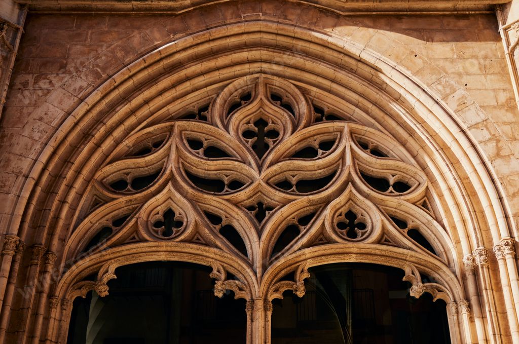 A closeup of decorated metal gothic art on an arch old door in  Palma city in Spain