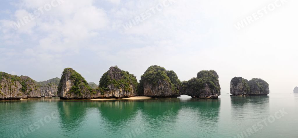 A panoramic shot of the rocks reflected in the water in Halong Bay, Vietnam