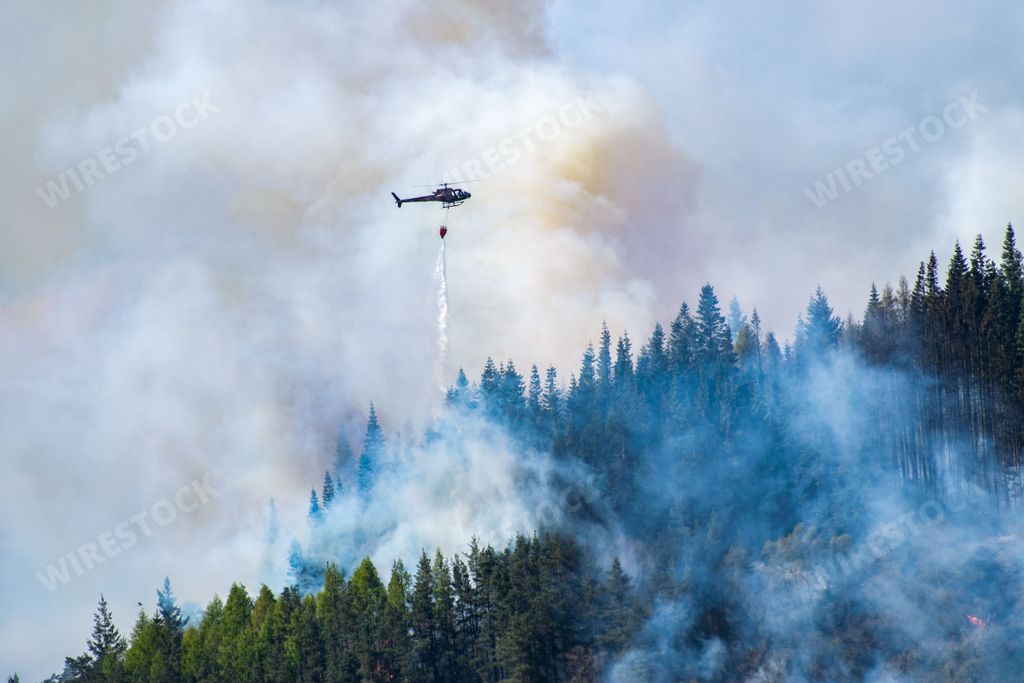 Firefighting helicopter extinguishing forest fire