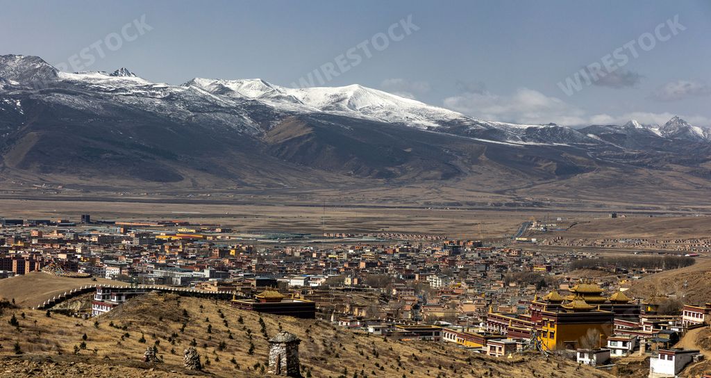 A panoramic view of a picturesque city of Litang, Sichuan, China, surrounded by snowy mountains