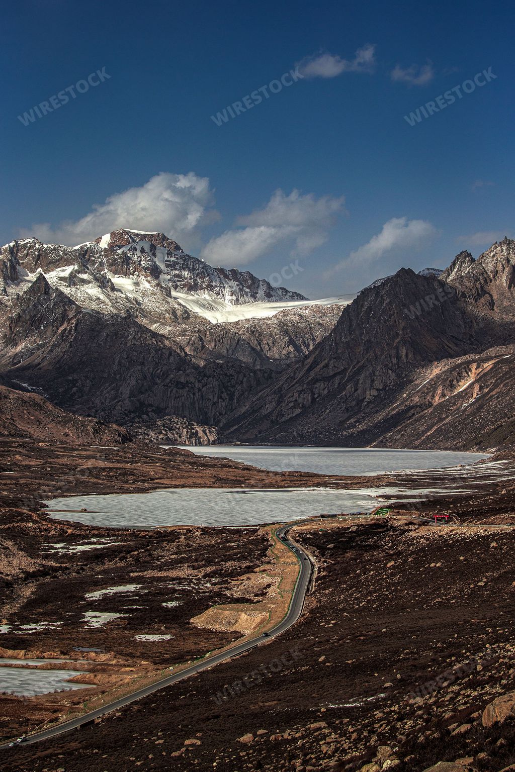 A vertical shot of the sister lakes on the Sichuan Tibet highway in China, surrounded by mountains and hills