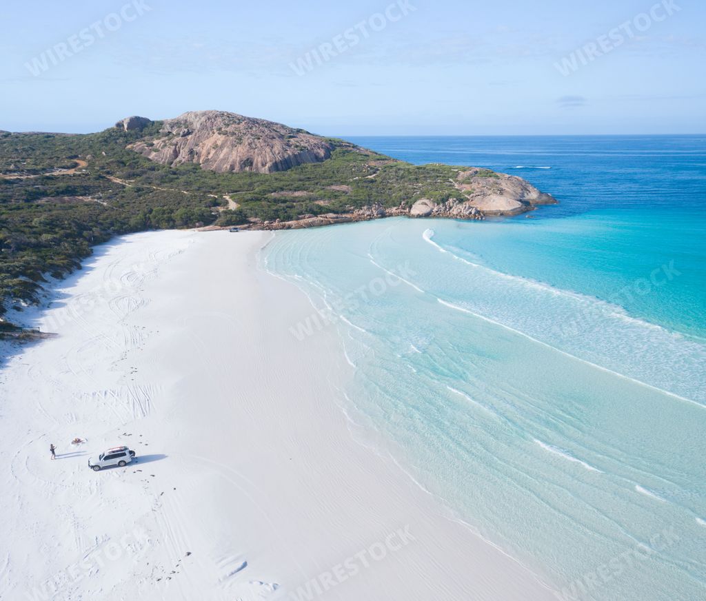A beautiful birds eye view shot of a truck at the beach