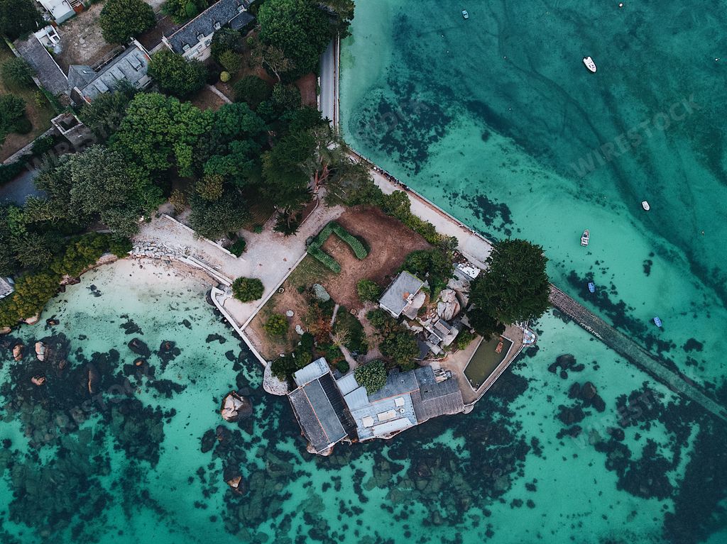 A birds-eye view of houses by stunning sea scenery