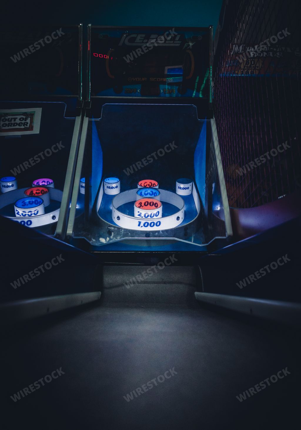 Buford, Georgia | United States - October 31, 2020: A lighted vintage Skee-Ball game in a darkened arcade
