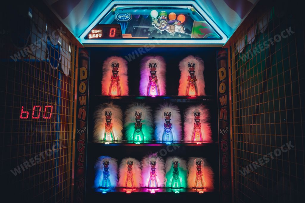 Buford, Georgia | United States - October 31, 2020: A lighted Down The Clown game in a darkened arcade