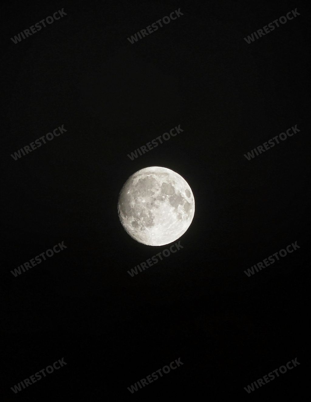 A vertical close-up shot of the Moon on a black background, perfect for wallpapers and backgrounds