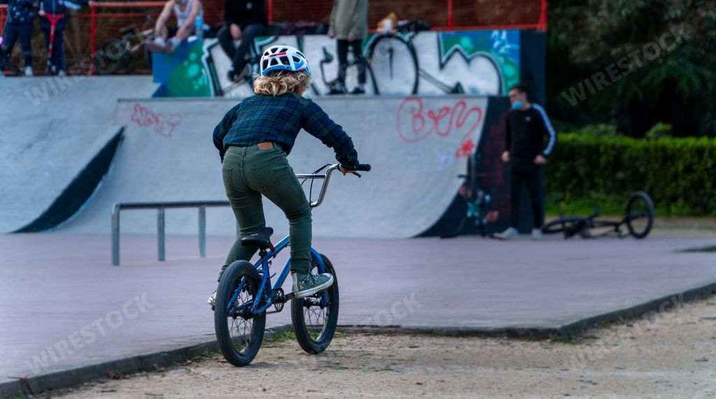 A young boy with a helmet riding a bike on a skatepark in Vigo, Spain