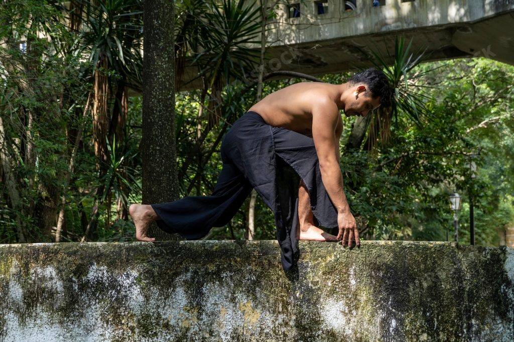A Mexican man doing yoga and stretching in the forest in Mexico, Guadalajara