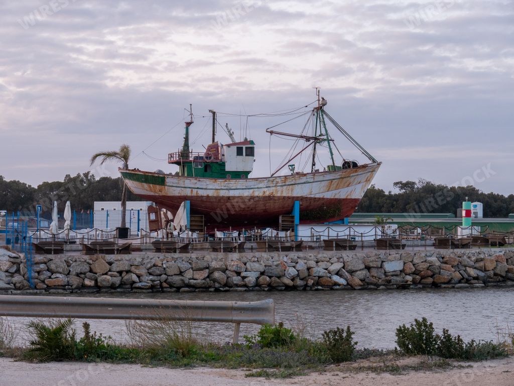A rusty historic ship on the shore of Tabarca Island in Alicante, Spain