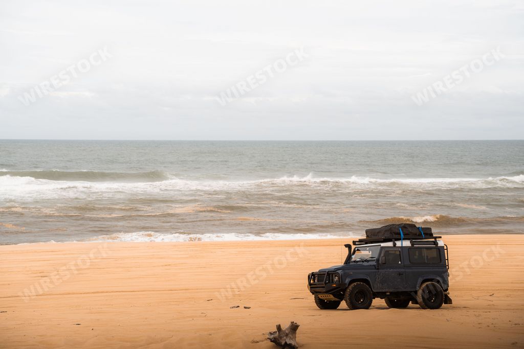 A Land Rover 4WD with camping equiptment parked on stockton beach, Newcastle, NSW.
