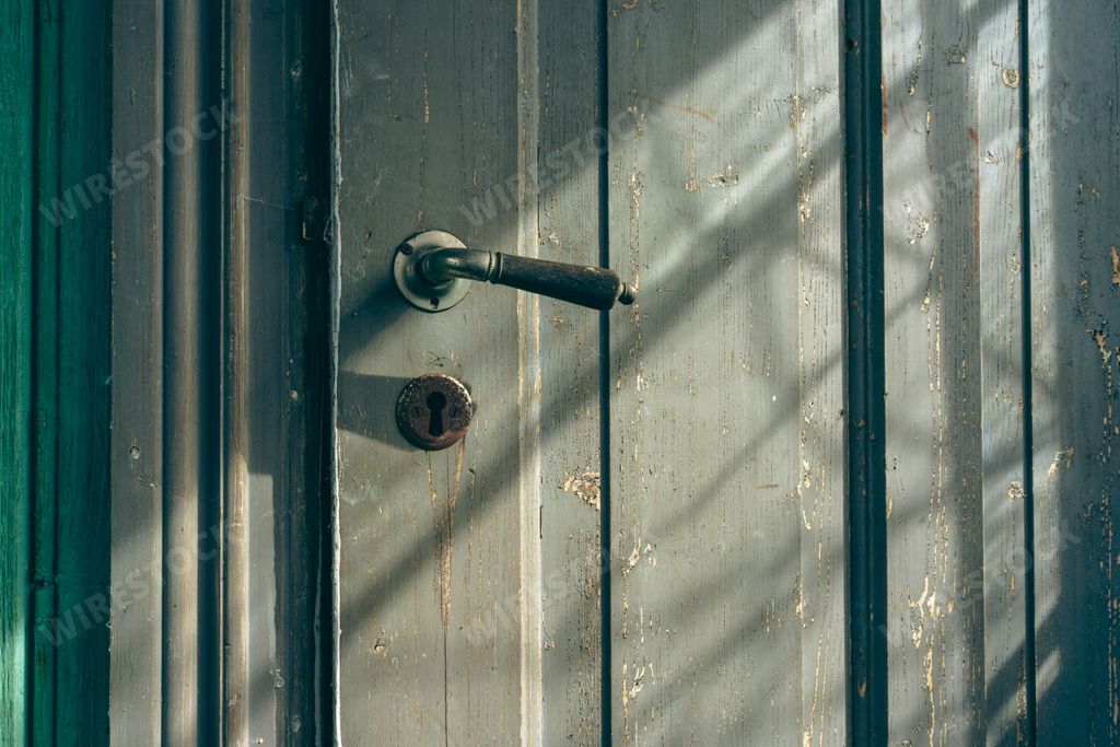 A closeup of an old farm house door handle