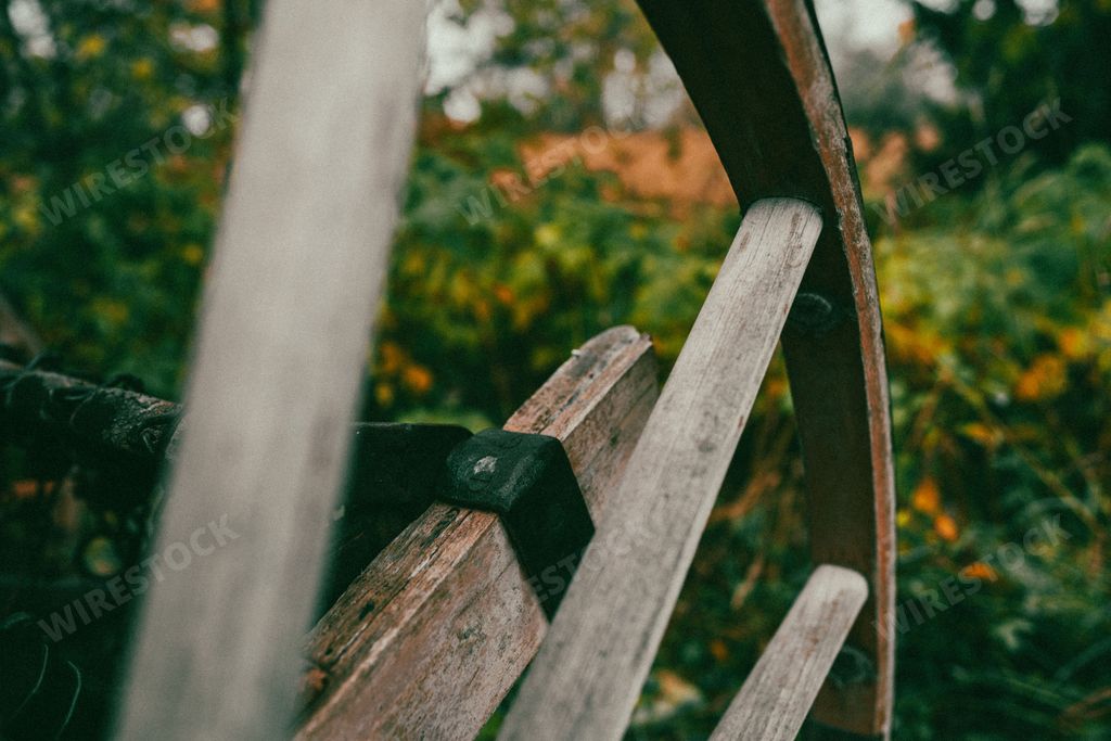 A wooden wheel of an old agricultural sowing machine for horse drift