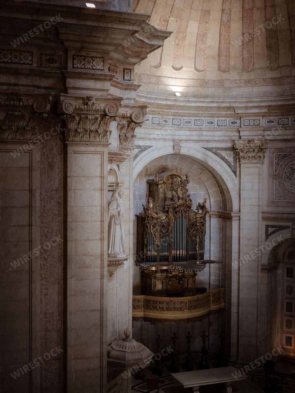 A vintage golden organ inside the National Pantheon church in Lisbon, Portugal, vertical shot