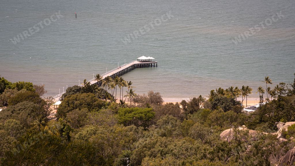 An awe-inspiring vista of Picnic and Cockle Bays on Magnetic Island in Townsville, Australia, with a picturesque landscape of lush vegetation