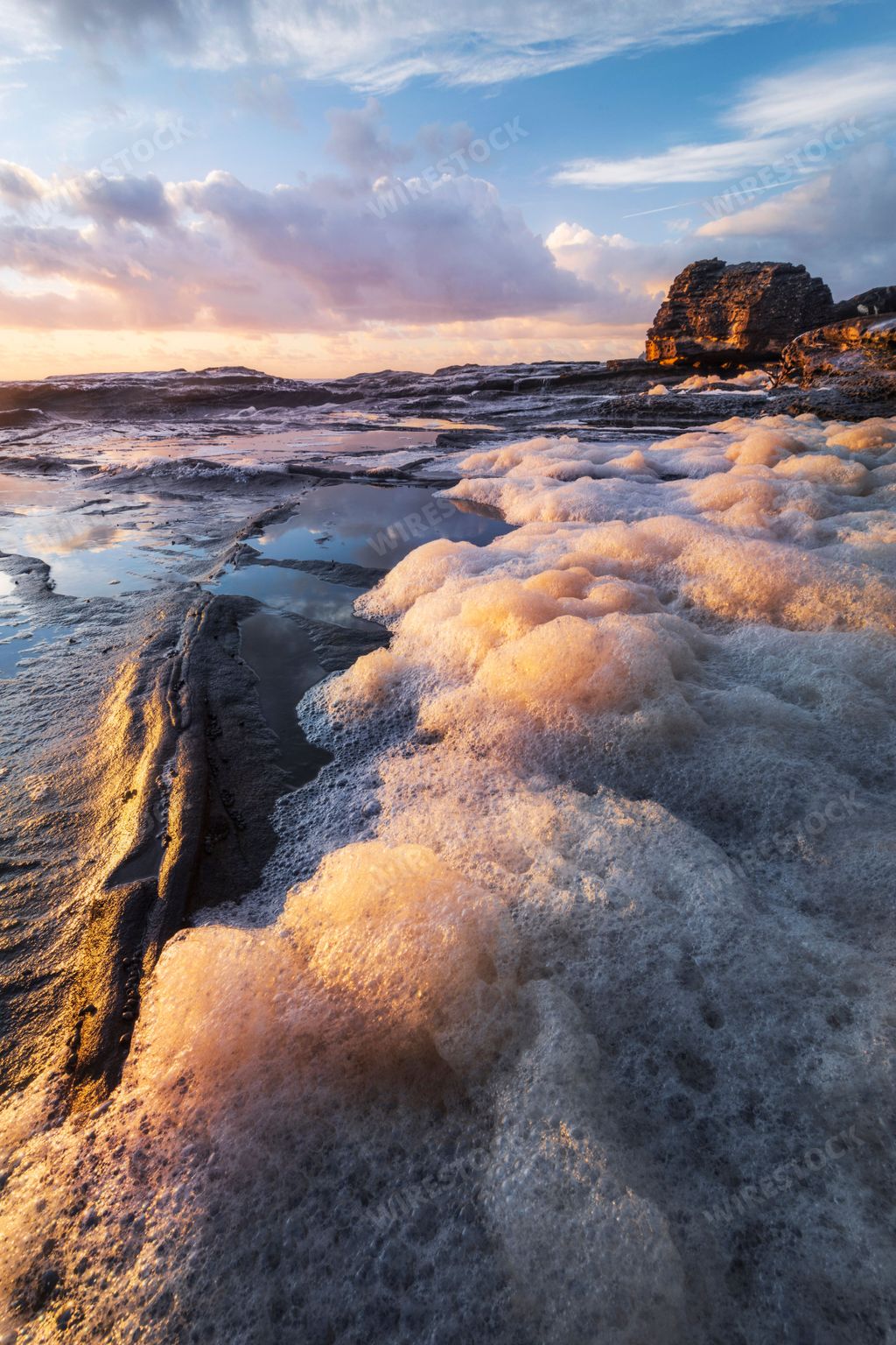 The first light on sea foam at Umina Beach on the Central Coast, NSW in Australia