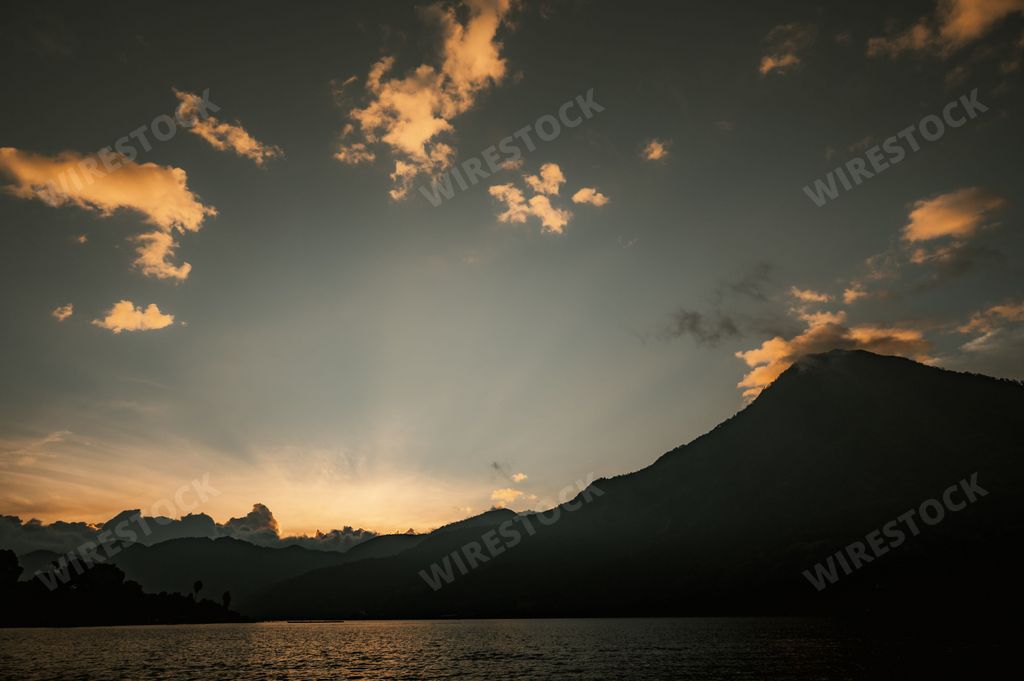 A silhouette of hills against the scenic sky at sunrise. The location is Santiago, Lake Atitlan, Guatemala