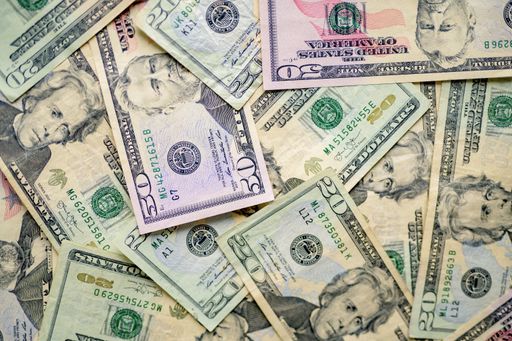 Overhead shot of different types of dollar bills on top of each other ...