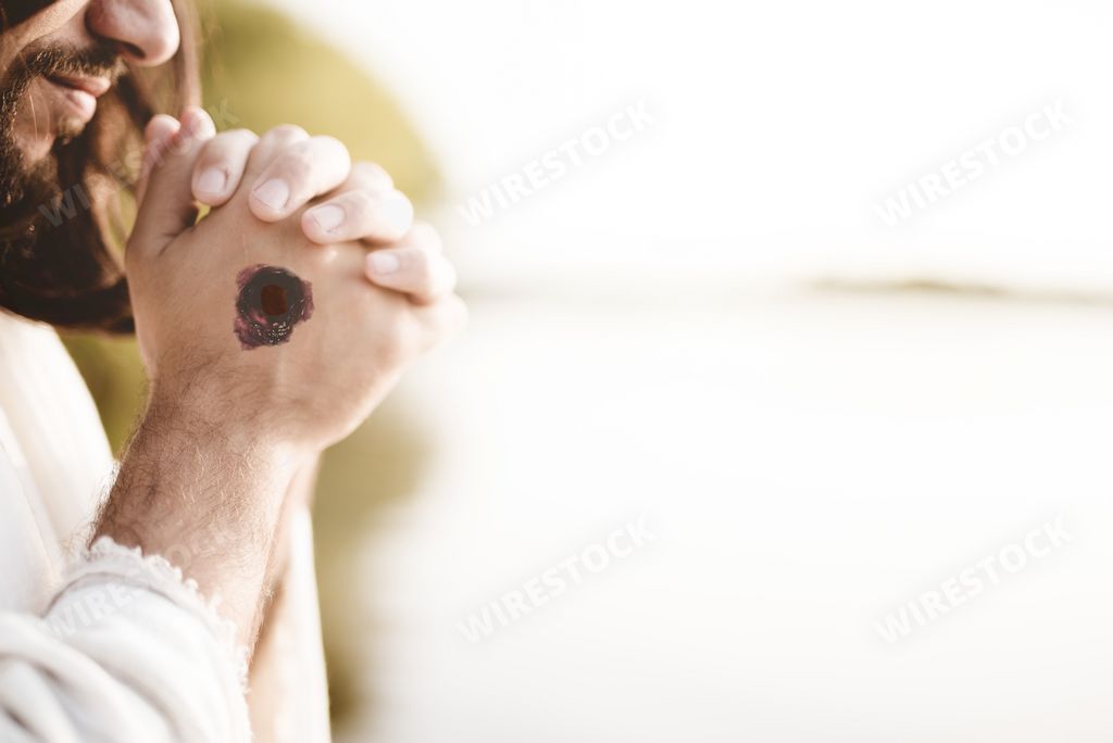 The Jesus Christ praying with the scars of the nails on his hands