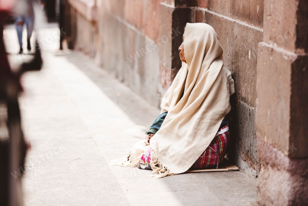 A shallow focus of a beggar on the side of the road begging for money and food in Zacatecas, Mexico