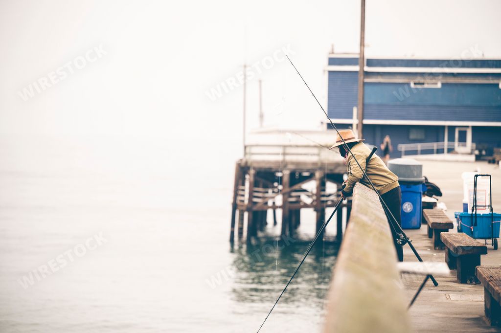 A shallow focus of a Fisherman fishing off the pier in Newport Beach, California